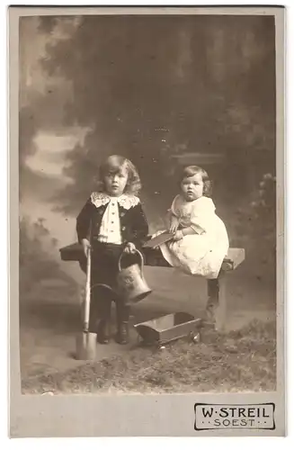 Fotografie W. Streil, Soest, Brüderstrasse 1a, Portrait hübsch gekleideter Junge mit Giesskanne und Kleinkind