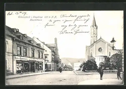 AK Eibenstock i. Erzgebirge, Hauptstrasse mit Geschäft und Kirche