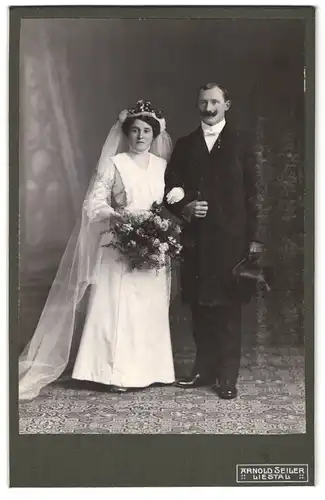 Fotografie Arnold Seiler, Liestal, Portrait Eheleute beim Hochzeitsfoto im weissen Kleid mit Schleier, Mann mit Zylinder