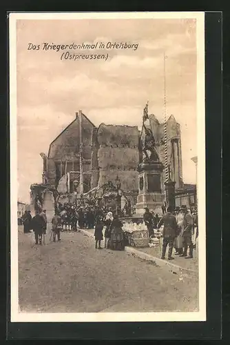 AK Ortelsburg, Kriegerdenkmal mit zerstörtem Gebäude