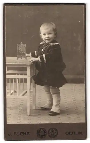 Fotografie J. Fuchs G. m. b. H., Berlin-N, Friedrichstrasse 138, Portrait hübsch gekleidetes Kind mit Herzkette