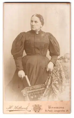 Fotografie H. Wittrock, Hamburg-St. Pauli, charmante Dame mit strengem Blick und Buch in der Hand