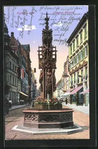 AK Freiburg i. Br., Strassenpartie mit gotischen Brunnen