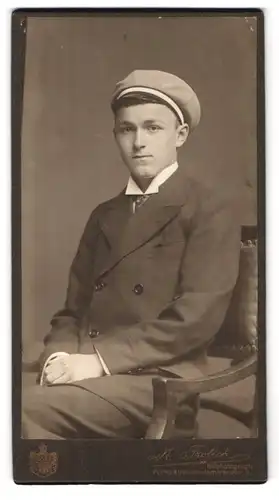 Fotografie M. Frölich, Flensburg, Norderhofenden 9, Portrait junger Student im Anzug mit Tellermütze