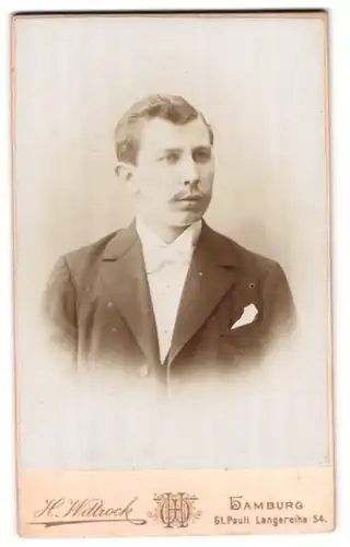 Fotografie H. Wittrock, Hamburg-St. Pauli, Langereihe 54, Portrait junger charmanter Mann mit Fliege im Jackett