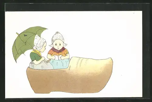 AK zwei Mädchen in niederländischen Trachtkleidern sitzen in einem grossen Holzschuh
