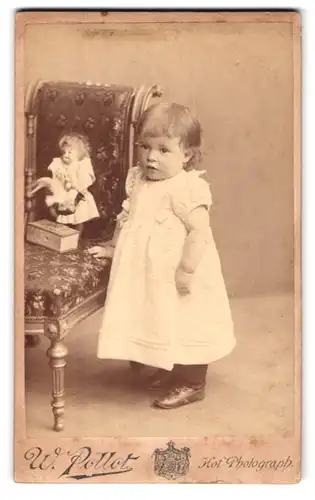 Fotografie Wilhelm Pollöt, Darmstadt, Hügelsstr. 59, Mädchen nebst Puppe auf Stuhl stehend