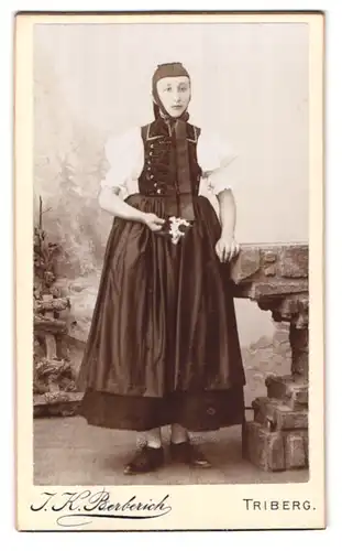 Fotografie J. K. Berberich, Triberg, Portrait Frau in Tracht vor einer Studiokulisse