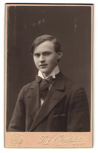 Fotografie K. J. A. Gardsten, Wisby, Portrait junger Mann im Anzug mit Fliege und Seitenscheitel