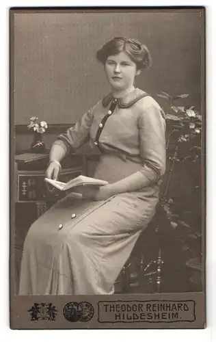 Fotografie Theodor Reinhard, Hildesheim, Goslarschestr. 23, Portrait Dame im modischen Kleid mit Buch in der Hand
