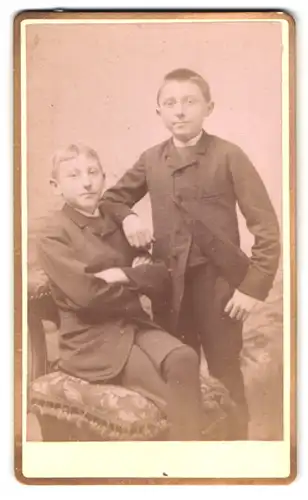 Fotografie R. Josz-Dongrie, Mons, Rue Rogier 8, Portrait Emil und Leon in Anzügen posieren im Atelier