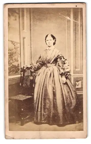 Fotografie British & Foreign Copying Co., London, Fleet Street 102, Portrait Dame im seidenen Kleid vor Studiokulisse