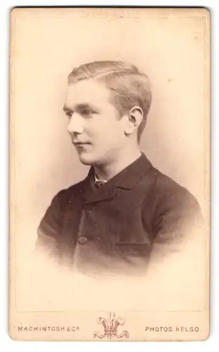 Fotografie Mackintosh & Co., Kelso, Junger Mann im Anzug mit Scheitel in Seitenansicht