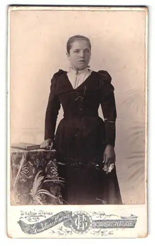 Fotografie Gustav Krenz, Schirgiswalde, Portrait junge Frau im schwarzen Kleid mit Brosche
