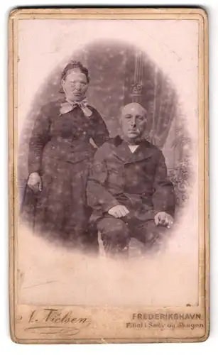 Fotografie N. Nielsen, Frederikshavn, Portrait zwei ältere Herrschaften im Anzug und Kleid mit Haube