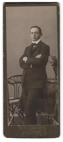Fotografie Fr. Brüggemann, Leipzig, Eisenbahn-Str., Portrait junger Mann im Anzug mit verschrenkten Armen