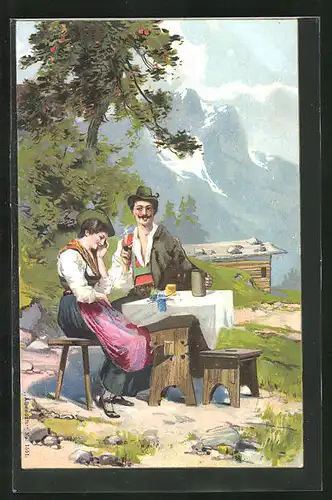 Künstler-AK junges Paar in Tracht am Tisch sitzend