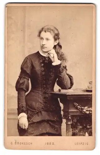 Fotografie C. Brokesch, Leipzig, Zeitzerstr. 48, Portrait junge Frau im schwarzen Kleid mit Locken