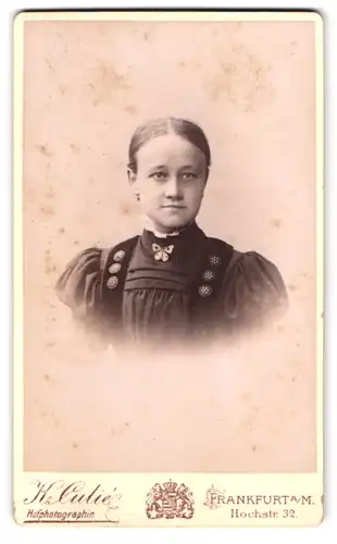 Fotografie K. Culie, Frankfurt a. M., Hochstr. 32, Portrait junge Frau im Kleid mit Schmetterlingsbrosche