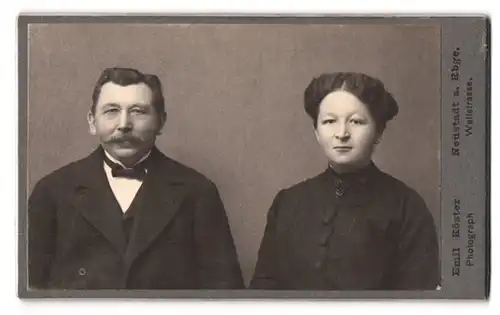 Fotografie Emil Köster, Neustadt a. Rbge., Wallstr., Portrait Herr und Frau im Anzug mit Fliege und schwarzes Kleid