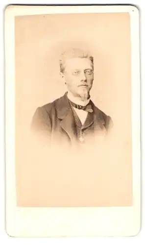 Fotografie Otto Patzig, Würzburg, am Mainquai, Portrait Herr im Anzug mit Fliege und Brille, Ziegenbart