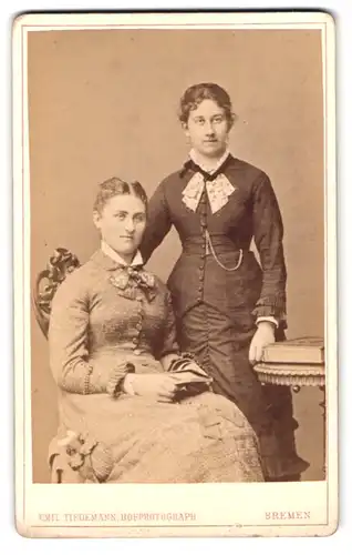Fotografie Emil Tiedemann, Bremen, Portrait zwei Damen in Biedermeierkleidern mit Schleifen