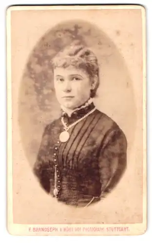 Fotografie F. Brandseph, Stuttgart, Marienstrasse 36, Portrait junge Frau im Biedermeierkleid mit Halskette und Locken