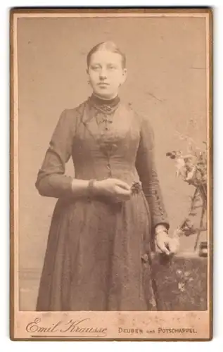 Fotografie Emil Krausse, Deuben, junge Frau in hochgeschlossenem Kleid neben einem Blumenstrauss