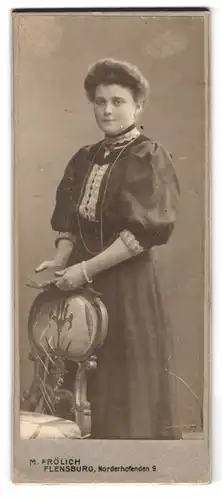 Fotografie M. Frölich, Flensburg, Norderhofenden 9, Portrait modisch gekleidete Dame mit Buch in der Hand