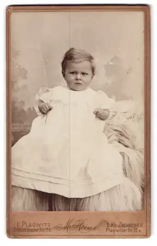 Fotografie M. Heine, Plagwitz, Zschocherschestr. 7b, Kleinkind im Taufkleid auf Felldecke sitzend
