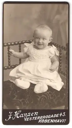 Fotografie J. Hansen, Kobenhavn, Vesterbrogade 43, Portrait niedliches Kleinkind weissen Kleid auf einem Stuhl