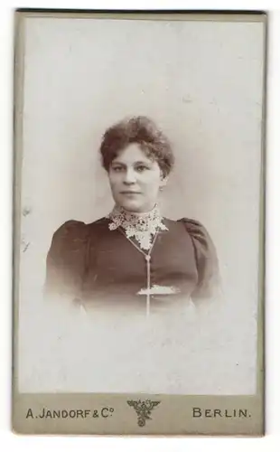 Fotografie A. Jandorf & Co., Berlin, Portrait brünette Dame mit lockigem Haar und besticktem Blusenkragen