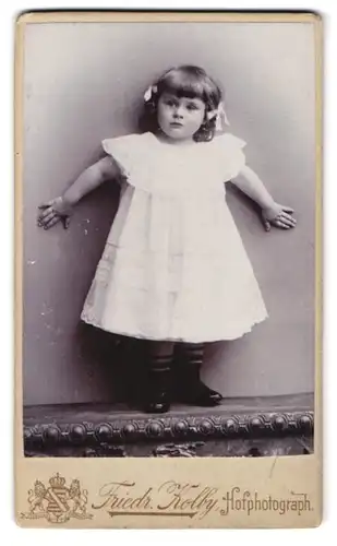 Fotografie Friedr. Kolby, Zwickau i. S., äuss. Plauensche Str., Portrait Mädchen im weissen kleid mit Haarschleifen