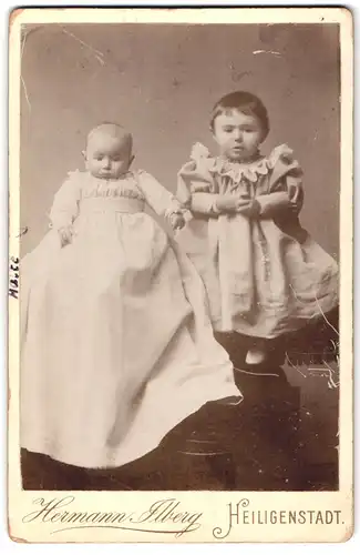 Fotografie Hermann Ilberg, Heiligenstadt, Portrait zwei Kinder in weissen Kleidern posieren im Atelier