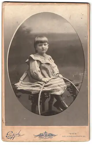 Fotografie J. Popjel, Wien, Währingerstrasse 96, Portrait kleines Mädchen im Kleid mit Reifen