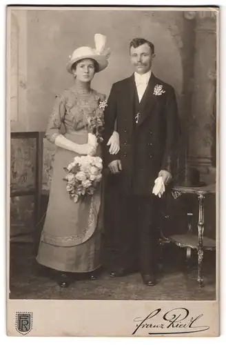 Fotografie Franz Riedl, Wien, Hauptstrasse 89, Portrait junges Paar in hübscher Kleidung mit Blumenstrauss