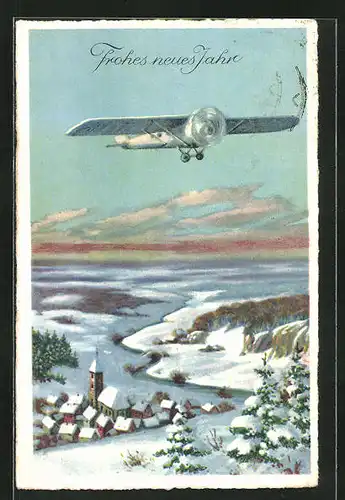 AK Flugzeug passiert eine verschneite Ortschaft, Neujahrsgruss