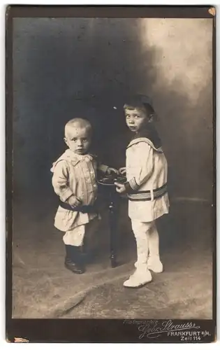 Fotografie Gebr. Strauss, Frankfurt a. M., Zeil 114, Portrait zwei junge Knaben in Matosenanzug und Kleid
