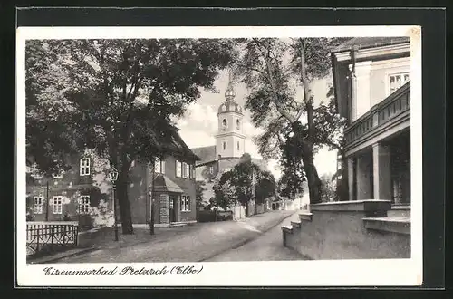 AK Pretzsch (Elbe), Strassenpartie mit Kirche