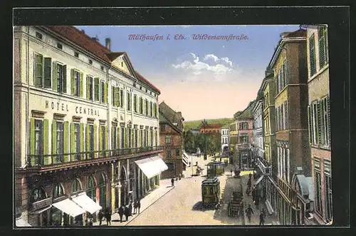 AK Mühlhausen i. Els, Blick in die Wildemannstrasse mit Strassenbahnen und Hotel Central