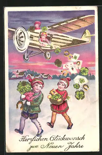 Künstler-AK Glücksbringerbomber, Neujahrsgruss, Flugzeug