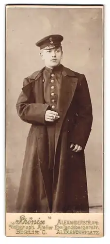 Fotografie Phönix, Berlin, Alexanderstr. 44, Portrait junger Postbeamter in Uniform mit Mütze