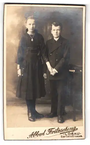Fotografie Alfred Fritzsching, Löbau, Gartenstrasse, Portrait halbwüchsiger Knabe im Anzug mit Mädchen an der Hand