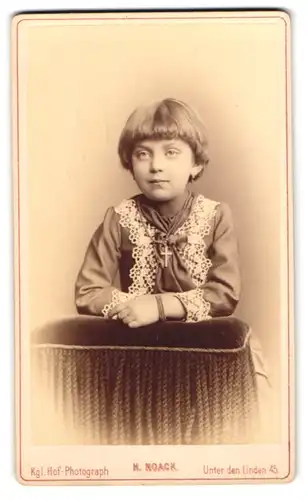 Fotografie N. Noack, Berlin, Unter den Linden 45, Portrait hübsch gekleidetes Mädchen mit Kreuzkette