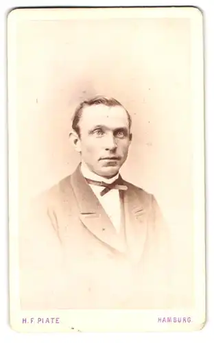 Fotografie H. F. Plate, Hamburg, Jungfernstieg 6, Portrait charmanter Herr im Anzug mit Fliege