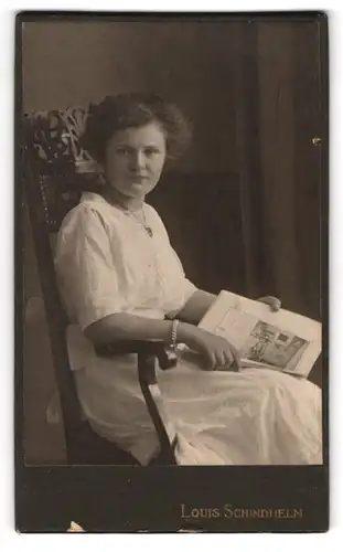 Fotografie Louis Schindhelm, Ebersbach i /S., Portrait junge Dame im weissen Kleid mit Zeitung
