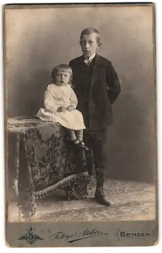 Fotografie Fotogr. Atelier, Bensen, Portrait halwüchsiger Knabe im Anzug mit kleinem Mädchen