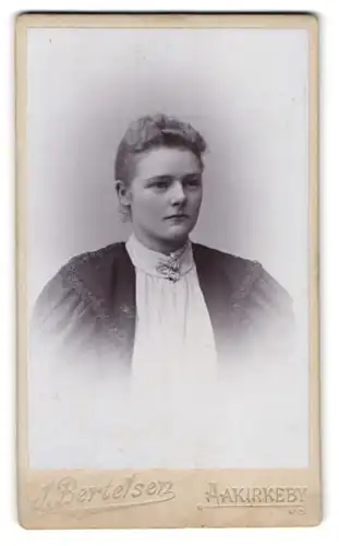 Fotografie J. Bertelsen, Aakirkeby, hübsche junge Dame mit Blumen am Kragen