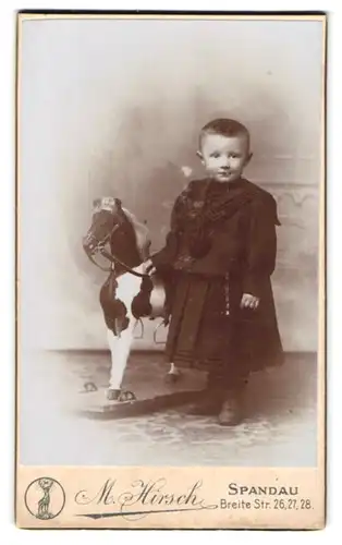 Fotografie M. Hirsch, Spandau, Breite Str. 26-28, Portrait kleines Kind im Kleid mit Schaukelpferd
