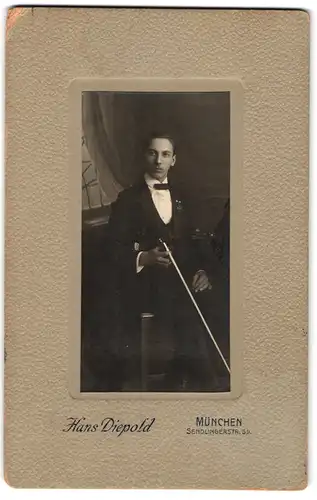 Fotografie Hans Diepold, München, Sendlingerstrasse 59, Portrait junger Herr im Anzug mit Instrument